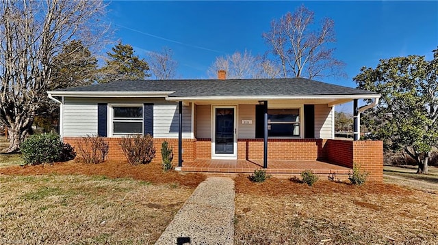 view of front facade with a front lawn and a porch