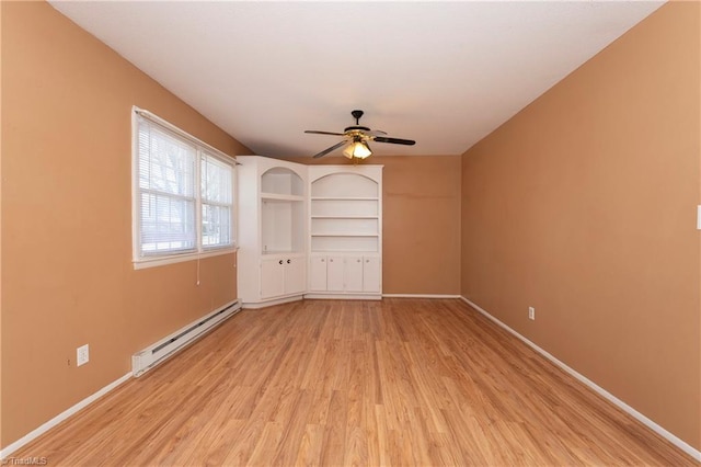 spare room with baseboards, light wood-type flooring, a baseboard heating unit, and a ceiling fan