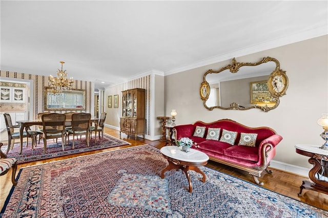 living room with ornamental molding, a chandelier, and parquet floors