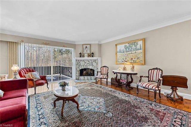 living room with crown molding, parquet floors, and a stone fireplace