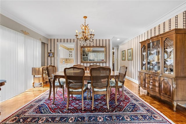 dining room featuring ornamental molding, parquet floors, and a chandelier