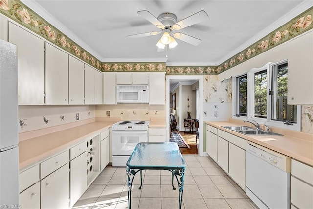 kitchen featuring sink, white appliances, white cabinetry, and light tile patterned flooring