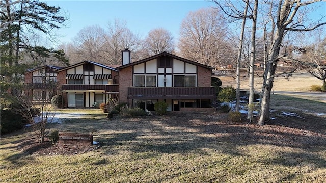 rear view of property featuring a yard