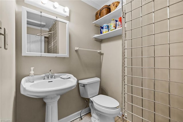 bathroom with toilet, tile patterned flooring, and ornamental molding