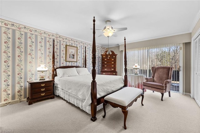 carpeted bedroom with a closet, ceiling fan, and crown molding