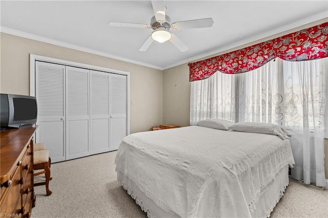 bedroom with multiple windows, a closet, ceiling fan, and ornamental molding