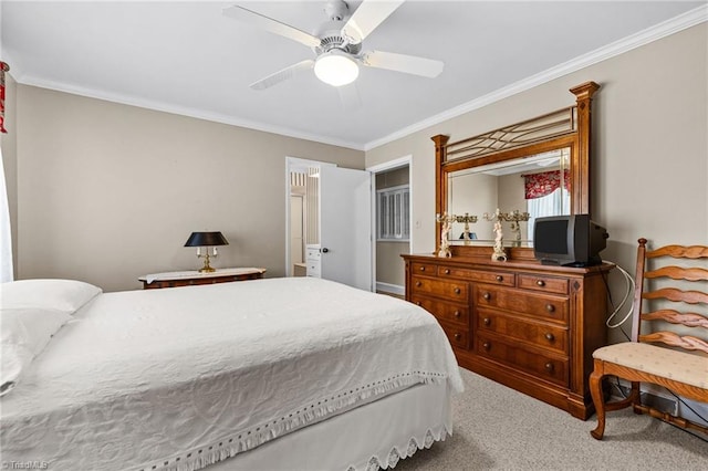 carpeted bedroom with ceiling fan and ornamental molding