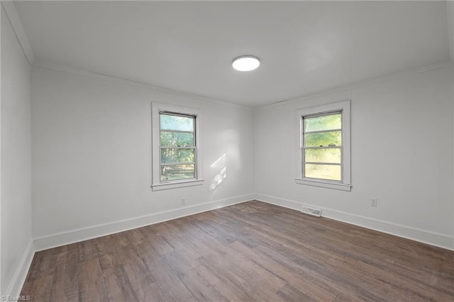 spare room featuring crown molding and wood-type flooring