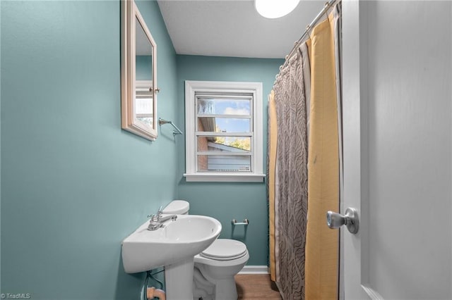 bathroom featuring toilet and hardwood / wood-style floors