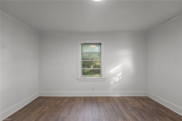 empty room featuring crown molding and dark hardwood / wood-style floors