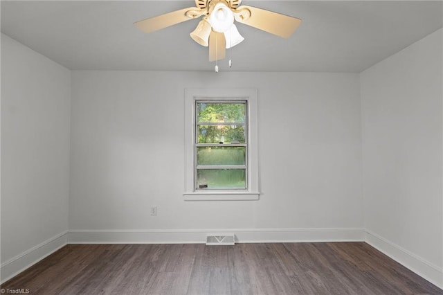 unfurnished room featuring dark wood-type flooring and ceiling fan