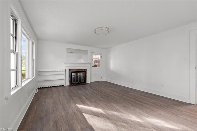 unfurnished living room with a fireplace and dark hardwood / wood-style flooring