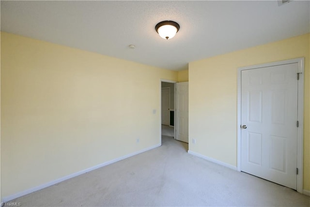 unfurnished bedroom featuring light colored carpet