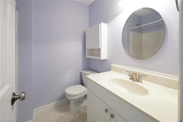 bathroom featuring vanity, tile patterned flooring, toilet, and walk in shower