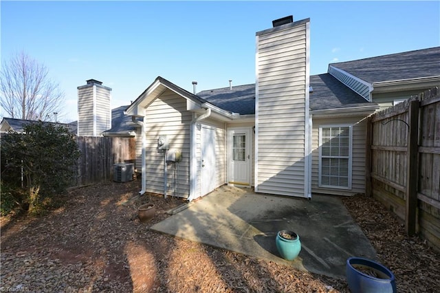 back of property featuring central AC and a patio area