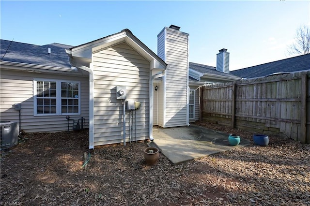 rear view of house featuring a patio area and central air condition unit