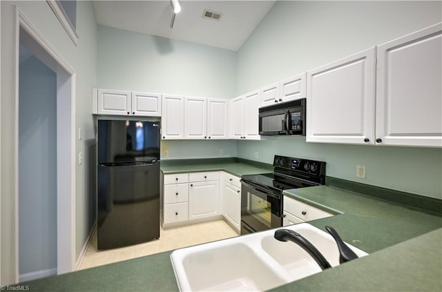 kitchen featuring white cabinetry, sink, a towering ceiling, and black appliances