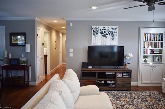 living room featuring ceiling fan, dark wood-type flooring, and crown molding