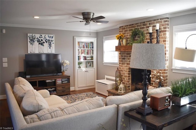 living room with ceiling fan, a fireplace, and crown molding