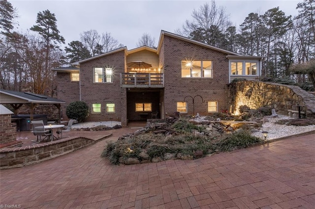 view of front of property featuring a gazebo, a patio, and a balcony