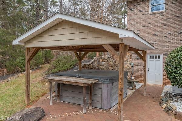 view of patio / terrace featuring a gazebo and a hot tub