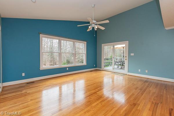 unfurnished room with light hardwood / wood-style flooring, high vaulted ceiling, and ceiling fan