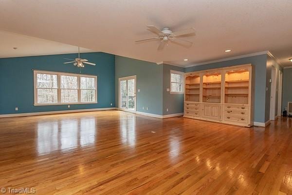 unfurnished living room featuring crown molding, lofted ceiling, ceiling fan, and light hardwood / wood-style floors