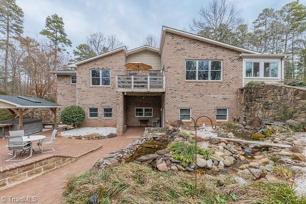 back of house with a balcony and a patio area