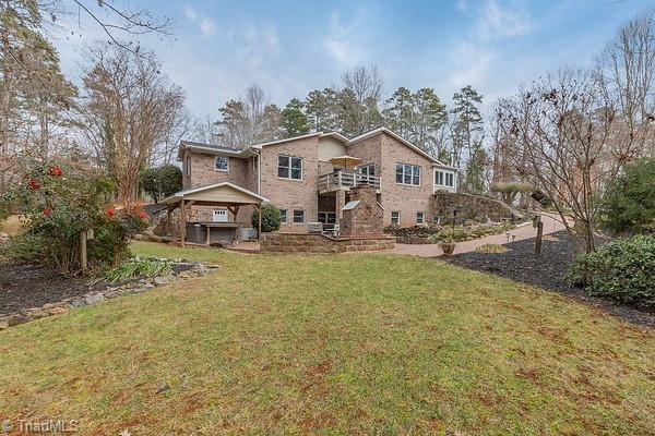 rear view of property with a lawn