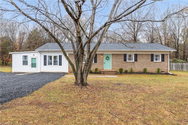 ranch-style home with a front lawn