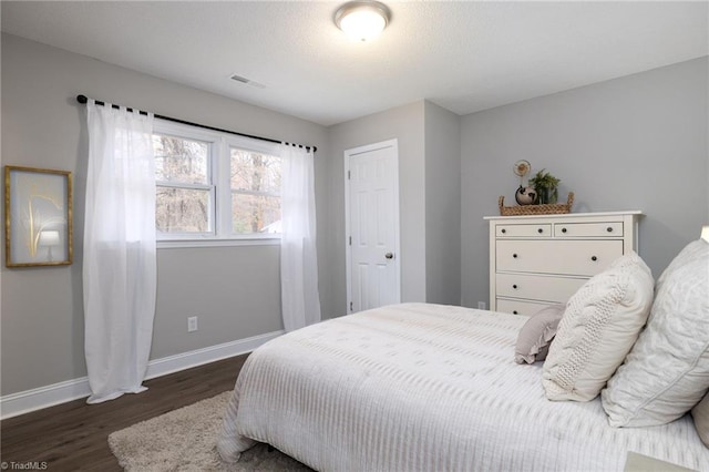 bedroom featuring dark hardwood / wood-style flooring