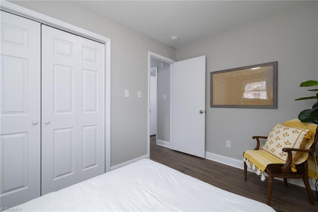 bedroom featuring dark hardwood / wood-style flooring and a closet