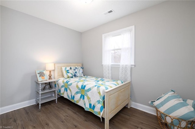 bedroom featuring dark hardwood / wood-style flooring