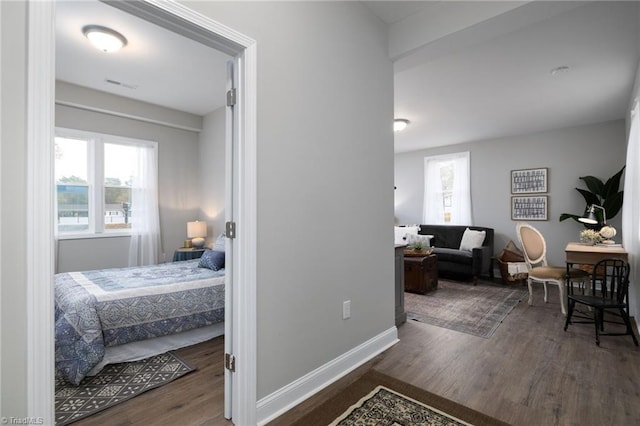 bedroom with dark hardwood / wood-style floors