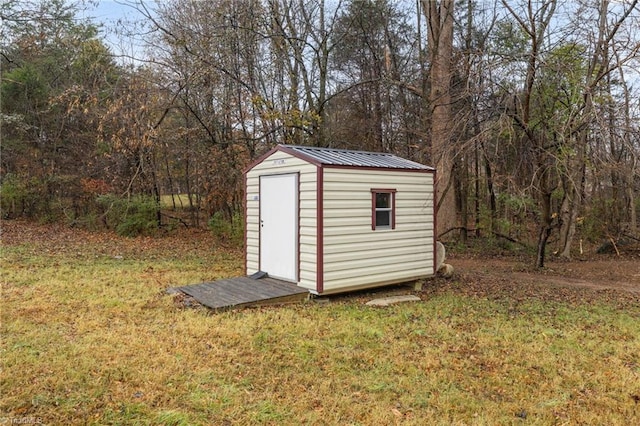 view of outbuilding with a yard