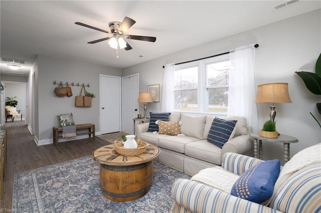 living room with dark hardwood / wood-style floors and ceiling fan