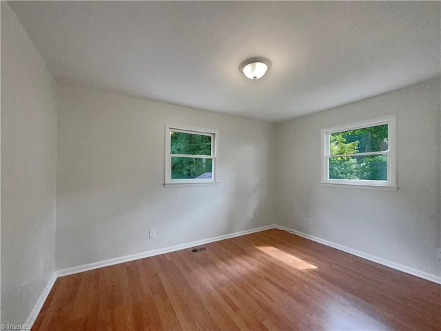 empty room with hardwood / wood-style flooring