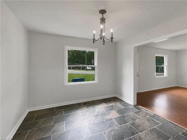 empty room featuring an inviting chandelier