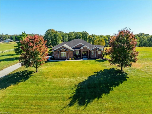 view of front facade featuring a front lawn and brick siding