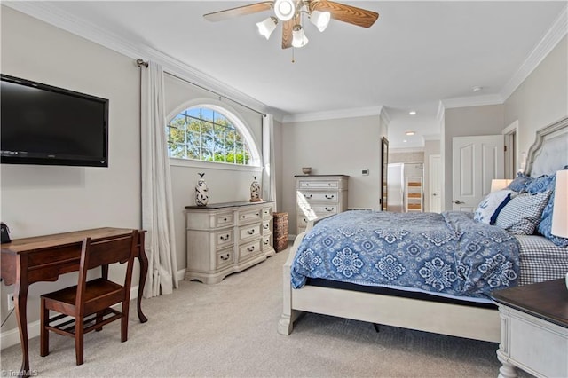 bedroom with crown molding, light colored carpet, ensuite bathroom, ceiling fan, and baseboards