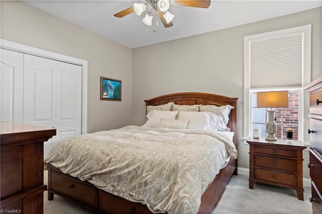 carpeted bedroom with a closet, ceiling fan, and baseboards