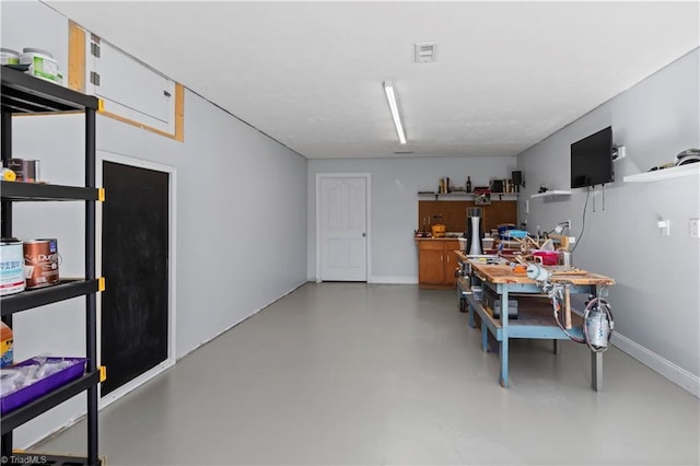 interior space featuring baseboards, visible vents, and concrete flooring