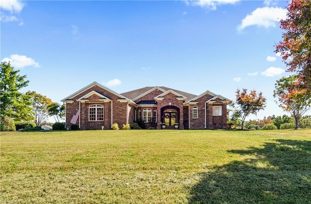 ranch-style home with a front yard and brick siding