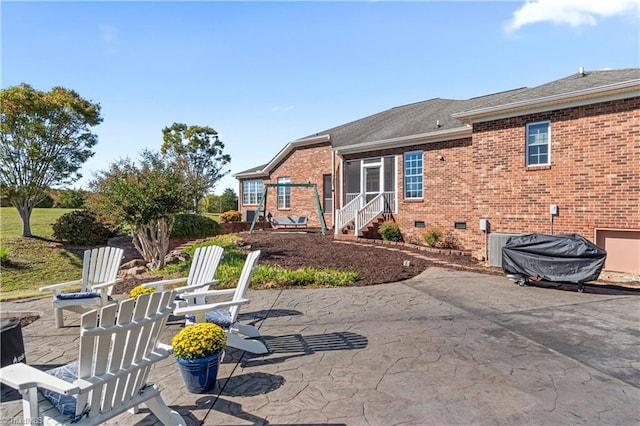 back of property with crawl space, a patio area, brick siding, and roof with shingles