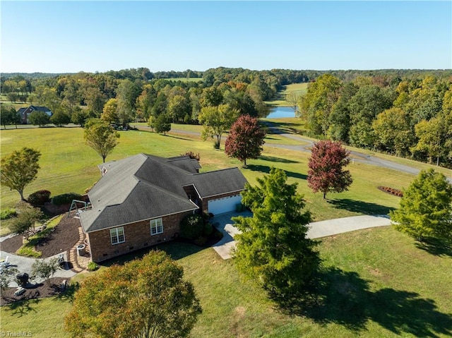 aerial view with a water view and a wooded view