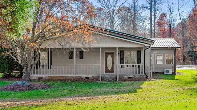 view of front of home featuring ac unit, a front yard, and a porch