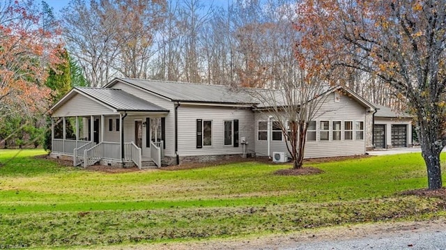 view of front facade with a garage, covered porch, and a front yard