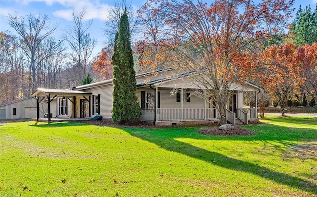 back of house featuring a porch and a lawn