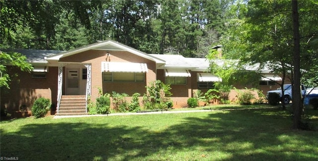 8521 US Highway 64 E, Ramseur, NC 27316 - ranch-style house featuring a front yard, brick siding, and a chimney