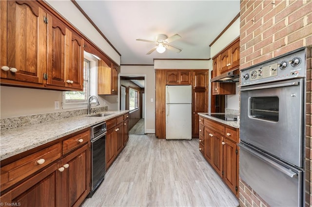 8521 US Highway 64 E, Ramseur, NC 27316 - kitchen featuring freestanding refrigerator, a sink, under cabinet range hood, a ceiling fan, and light wood-style floors